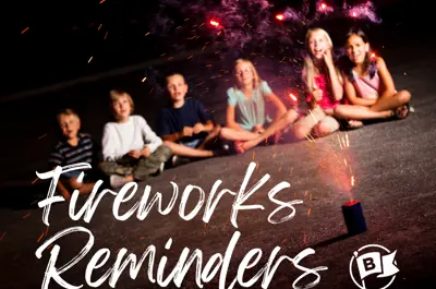 Kids sitting on the concrete watching a firework display