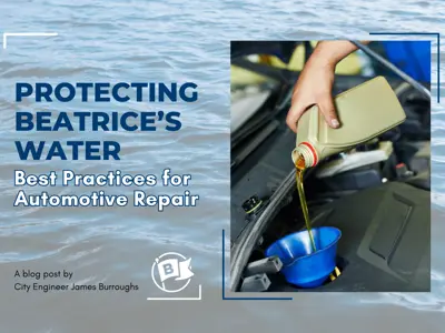 A hand pours golden oil from a tan plastic container into a blue funnel placed in a car's engine bay.