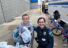 Officer and child in shopping cart
